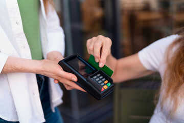 Woman Making Payment With Credit Card at Cafe on  Sunny Afternoon