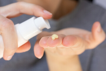 Closeup of a woman using retinal serum.