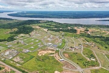 Vista aérea feita com drone de loteamento habitacional com rio ao fundo no Brasil