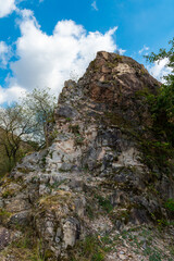 rocky mountain with a cloudy sky in the background