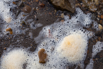 dirty foam is the result of river pollution by sewage