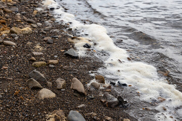 dirty foam is the result of river pollution by sewage