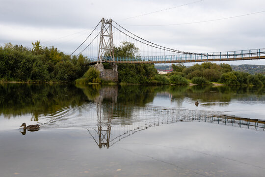 Fototapeta pedestrian rope bridge across the river