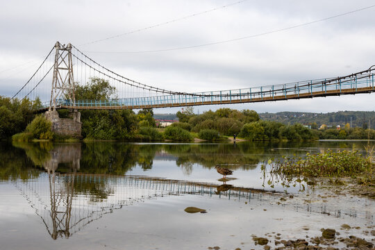 Fototapeta pedestrian rope bridge across the river