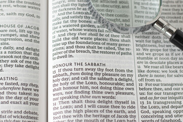 Honor the Sabbath verse in open holy bible book with magnifying glass. Christian biblical concept...