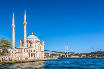 Obraz premium The Bosphorus Bridge or 15th July Martyrs Bridge and the Ortakoy Mosque during summer sunny day in Istanbul, Turkey