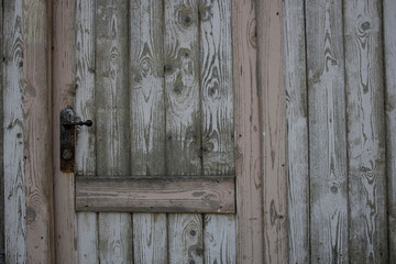 A door with a rusty lock and a wooden frame