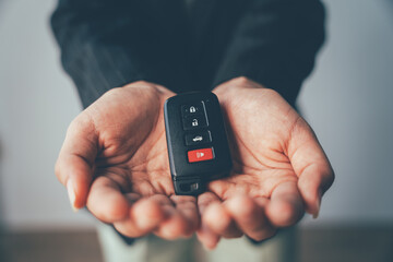 Keys to Freedom: A new car key rests in open palms, symbolizing fresh starts, exciting journeys, and the thrill of the open road.