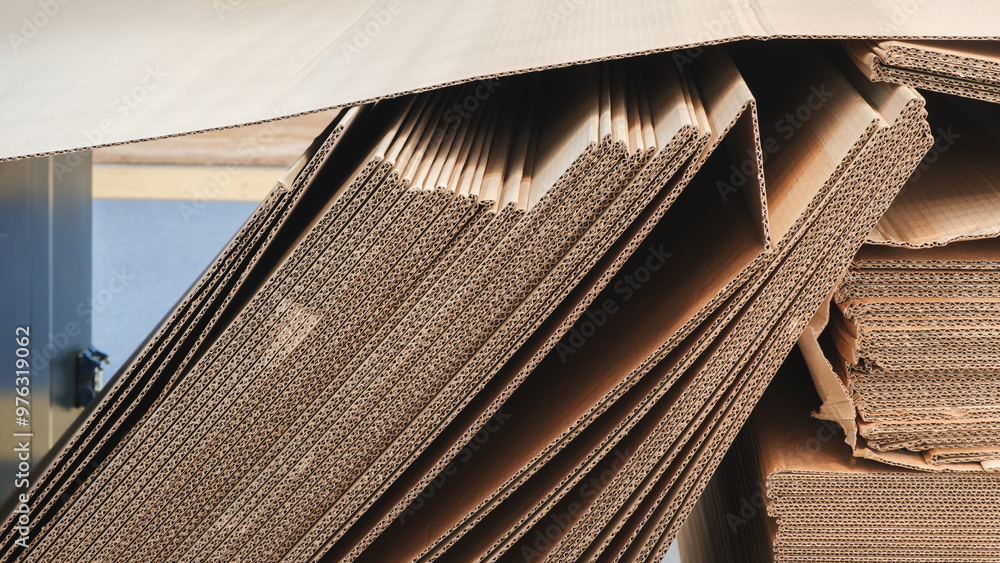 Aufkleber A stack of brown cardboard boxes. The boxes are stacked on top of each other and are brown in color