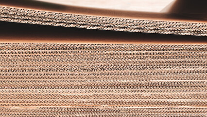 A stack of brown cardboard boxes. The boxes are stacked on top of each other and are brown in color