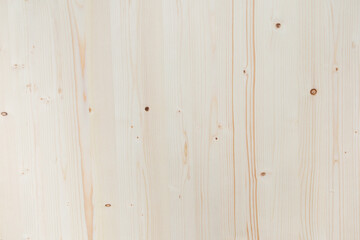A wooden surface with a grain pattern and a few holes. The surface is white and has a natural, rustic feel to it