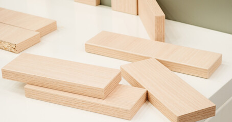 A stack of wooden blocks on a table. The blocks are of different sizes and are arranged in a way that they look like a puzzle. Concept of creativity and craftsmanship