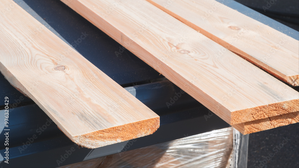 Poster three wooden boards are stacked on top of each other. the boards are made of wood and are arranged i