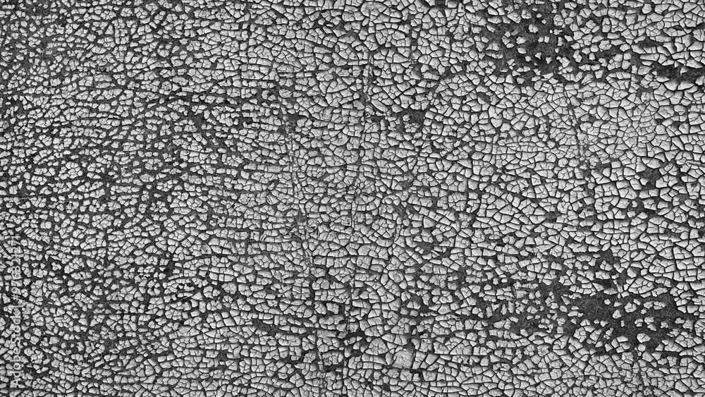 Poster the image is a close up of a wall with a lot of cracks and holes. the wall appears to be old and wor
