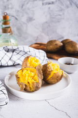 Young potatoes boiled in their skins on a plate on the table vertical view