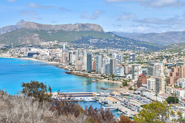 Naklejka premium Breathtaking Panoramic View of Calpe Spain Showcasing Azure Mediterranean Sea Yachts Iconic Penon de Ifach Rock Costa Blanca Paradise. Sun-Drenched Costa Blanca Aerial Perspective Calpe Revealing