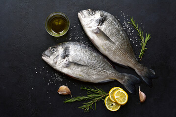 Raw organic dorado with ingredients for making . Top view with copy space.