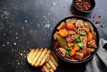 Goulash (meat stew with tomatoes and paprika) - traditional dish of hungarian cuisine.