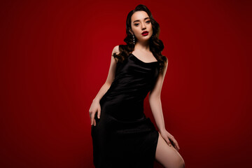 Photo of stunning attractive alluring lady model posing in black dress isolated on red color background
