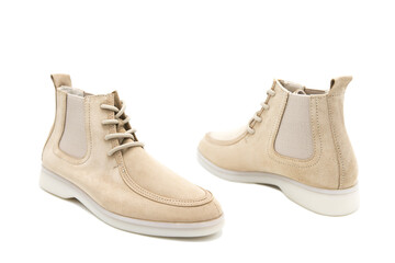 Pair of fashionable suede leather boots isolated on white background. View from all sides.	