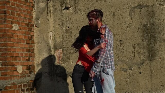 Halloween Zombie couple in blood dancing. Bloody Zombie. Sexy couple Full of blood. Bloody Halloween couple in love. Halloween couple of bearded man and young woman. Bloody Halloween make up.