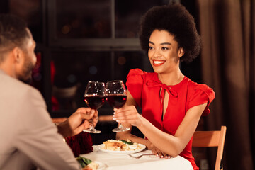 Romance On Valentine's Day. African American Couple Of Lovers Clinking Glasses Dating And Having Dinner In Restaurant. Selective Focus