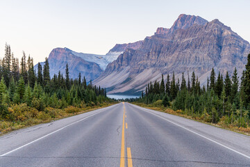 Scenic Road Through Majestic Mountains in Banff, Alberta, Canada with Lush Greenery and Clear Skies