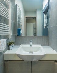 Compact bathroom design with wall-mounted sink and vertical storage for small apartments