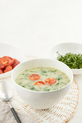 Typical Portuguese soup Caldo Verde with bread and cabbage on white background