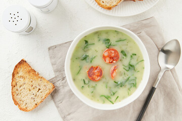Portuguese style soup Caldo Verde with bread on white table