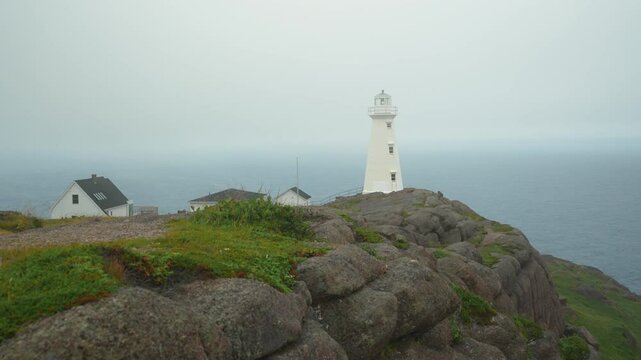 The Cape Spear lighthouse beacon serves as a warning to ships on a foggy day in Newfoundland