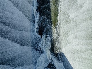 Water flowing over the spillway at the Lower Nihotupu Dam, Auckland, Auckland, New Zealand.