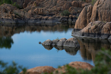 A rock island on a beautiful calm lake