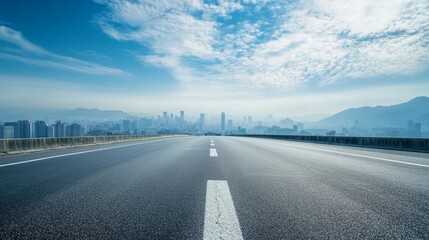 Empty road with panoramic cityscape