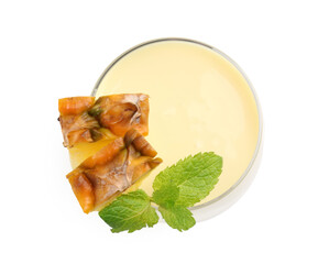 Tasty pineapple smoothie with slices of fresh fruit and mint in glass isolated on white, top view