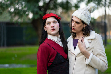 Couple of transgender women posing sensually in a park