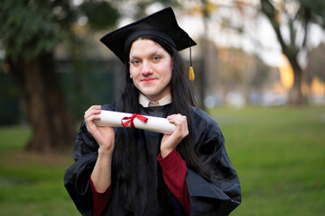 Transgender woman recent graduated, dressed in cap and gown, showing off his degree celebrating.
