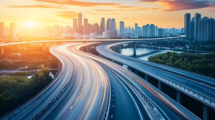 Fototapeta premium Highway overpass motion blur with city skyline background . Sunset scene .