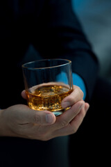 Young Asian businessman stressed from drinking alcohol, depressed man alone drinking on the couch at home, alcohol addiction treatment, alcohol addiction problem