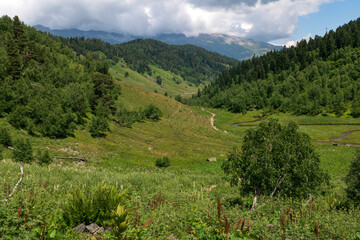 The valley of the Malaya Dukka River surrounded by the mountains of the North Caucasus and the tourist trail to the Dukka Lakes on a sunny summer day, Arkhyz, Karachay-Cherkessia, Russia © Ula Ulachka
