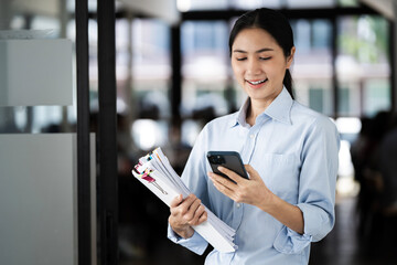 Happy asian woman, phone and communication at office with smile in networking or social media. Asian female person or employee enjoying online browsing or chat on mobile smartphone app at workplace