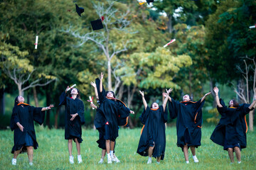 Concept of accomplishment and pride as the graduates stand together in a field