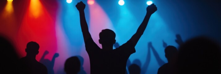 This image captures the silhouette of a person with raised hands expressing joy and enthusiasm...