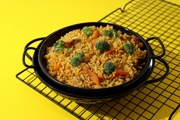 A tart with pilaf, on a yellow background.
