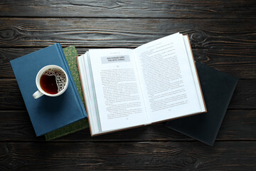 A stack of books on a dark wooden background