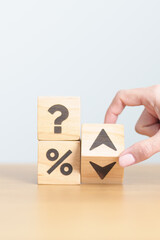 wood block of Question mark with percentage change to UP and Down arrow. Interest rate, GDP, stocks market, financial, deflation and Inflation, ranking, mortgage, debt, Loan and Economic Recession