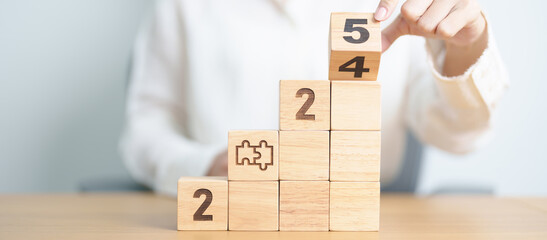 2024 year change to 2025 year block with jigsaw puzzle icon. Business Process, Team, teamwork,...