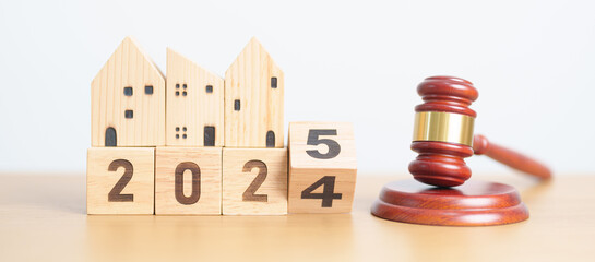 2024 end year to Happy New Year 2025 with small toy house model with gavel justice hammer on desk in courthouse. Real Estate Law, Home Insurance, property Tax, Auction and Bidding concepts