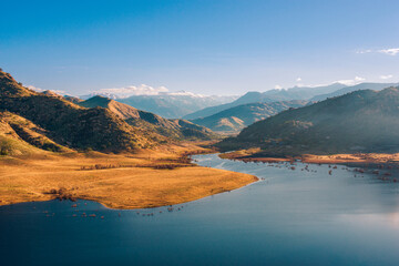 landscape of lake and hills at sunrise