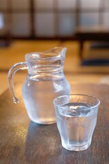 Glass and pitcher of water